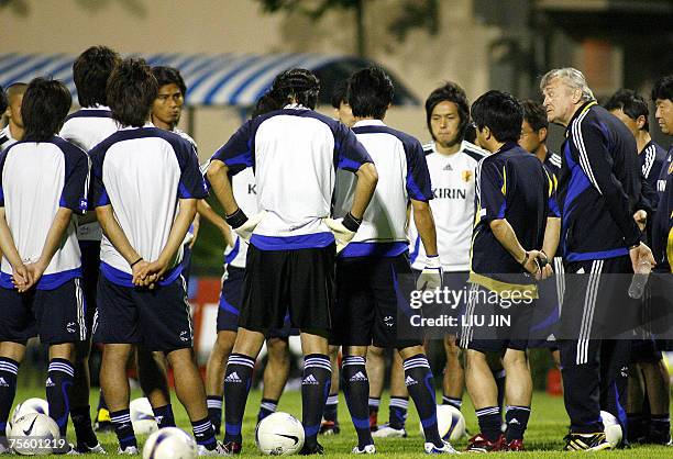 Japan's football team coach Ivica Osim of Bosnia briefs to his players during a team training session in Hanoi, 23 July 2007. Japan defeated...