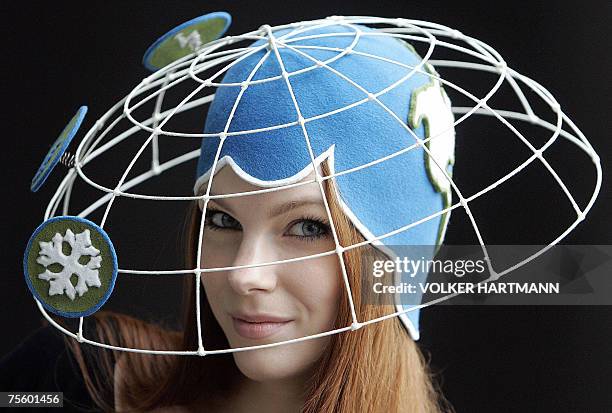 Model Mara presents the hat "Klima-Gipfel" by German label " Anna Caroline Menzel" during a photo shooting at the Igedo fashion fair in Duesseldorf,...