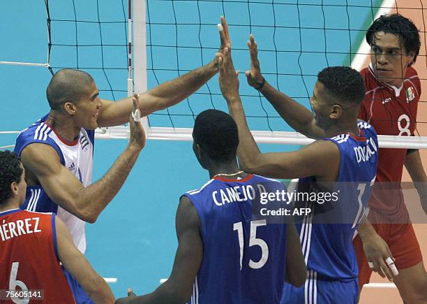 Rio de Janeiro, BRAZIL: Cuba's Pavel Pimienta celebrates with teammates Osdelvis Dominico , Oriol Camejo and Keibel Gutierrez after scoring a point...