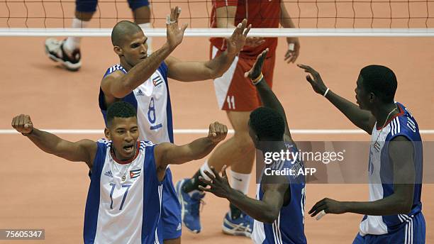 Rio de Janeiro, BRAZIL: Cuba's Osdelvis Dominico celebrates with teammates Pavel Pimienta , Raydel Hierrezuelo and Oriol Camejo after scoring a point...