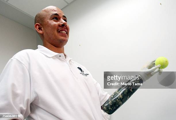 Retired U.S. Army Sergeant Juan Arredondo, a veteran of the war in Iraq, wears the world's first bionic hand with independently moving fingers July...