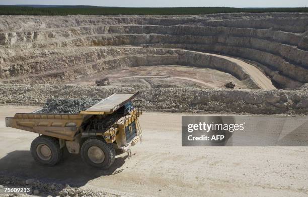 One-hundred ton Caterpillar truck carries ore from the Sue E open pit uranium mine at Areva Resources 16 July 2007 in McClean Lake, Canada. Twenty...