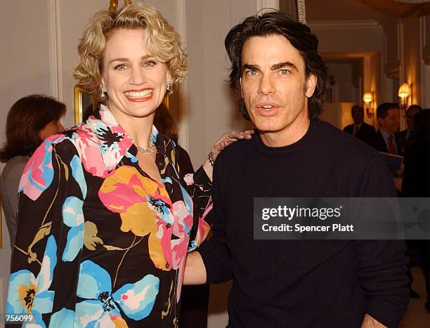 Actress Cady Huffman and actor Peter Gallagher pose for photographers at the jewelery store The House of Harry Winston March 5, 2002 in New York...