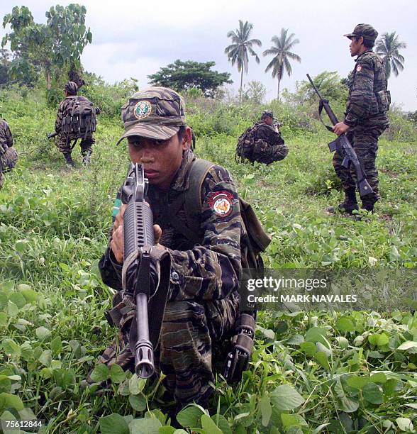 Muslim separatist rebels from the Moro Islamic Liberation Front conduct combat exercise at a guerrilla camp in Shariff Kabunsuan province in southern...