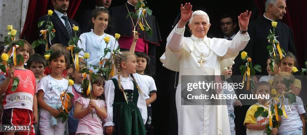 Pope Benedict XVI waves to belivers as he visits the Church of Santa Giustina Martire in Auronzo during his holidays in Lorenzago di Cadore, northern...