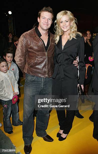 Actor Matt Passman and Actress Rachel Carpani arrive on the yellow carpet at "The Simpsons Movie" Australian premiere at Hoyts Entertainment Quarter,...