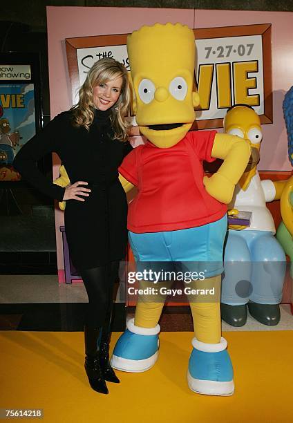 Tv Host Sophie Falkiner poses with Bart Simpson on the yellow carpet at "The Simpsons Movie" Australian premiere at Hoyts Entertainment Quarter,...