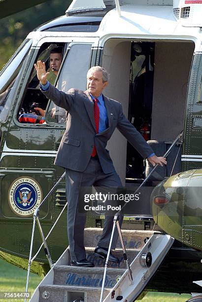 President George W. Bush waves to the cameras as he boards Marine 1 on the South Lawn of the White House July 24, 2007 in Washington, D.C. The...