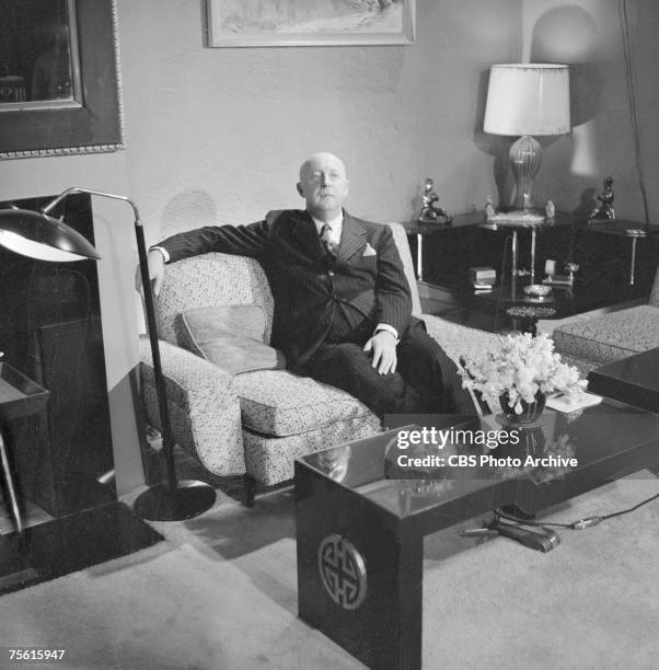 French fashion designer Christian Dior sits on a sofa for a broadcast of the CBS celebrity interview program 'Person to Person,' November 7, 1955.