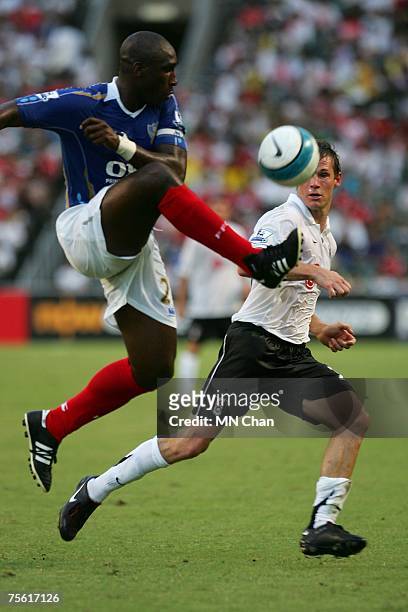 Brian McBride of Fulham battles with Sol Campbell of Portsmouth during the pre-season Barclays Asia Trophy match between Portsmouth FC and Fulham FC...