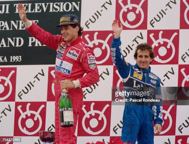 Ayrton Senna of Brazil and driver of the Marlboro McLarenMcLaren MP4/8Ford HBE7 V8 stands on the podium with second placed Alain Prost after winning...
