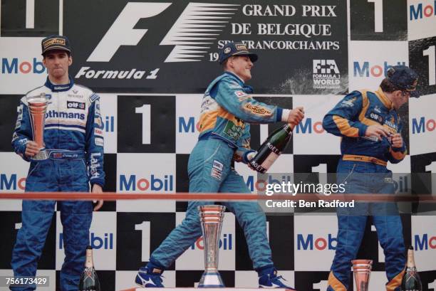 Michael Schumacher of Germany and driver of the Mild Seven Benetton Renault Benetton B195Renault RS7 V10 sprays champagne over third placed Martin...