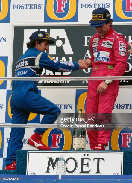 Ayrton Senna of Brazil and driver of the Marlboro McLarenMcLaren MP4/8Ford HBE7 V8 openly welcomes second placed Alain Prost on to the top step of...