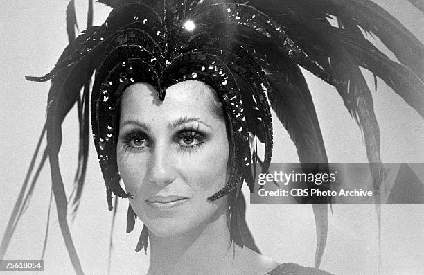 Portrait of American singer and entertainer Cher in a large, feathered headdress on an episode of 'The Sonny and Cher Comedy Hour,' January 18, 1973.