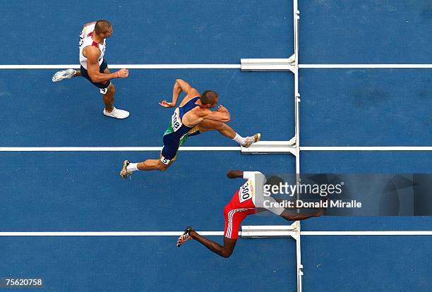 Chris Boyles of the United States, Carlos Chinin of Brazil and Leonel Suarez of Cuba compete in the second heat of the 110 meter hurdles of the Men's...