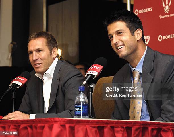 Jason Kapono of the Toronto Raptors and Raptors President and GM Bryan Colangelo attend a press conference covering Kapono's signing to the Raptors...