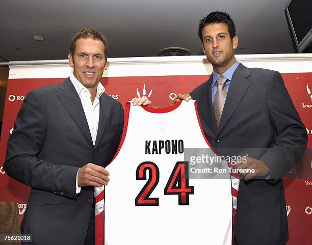 Jason Kapono of the Toronto Raptors and Raptors President and GM Bryan Colangelo pose at a press conference covering Kapono's signing to the Raptors...