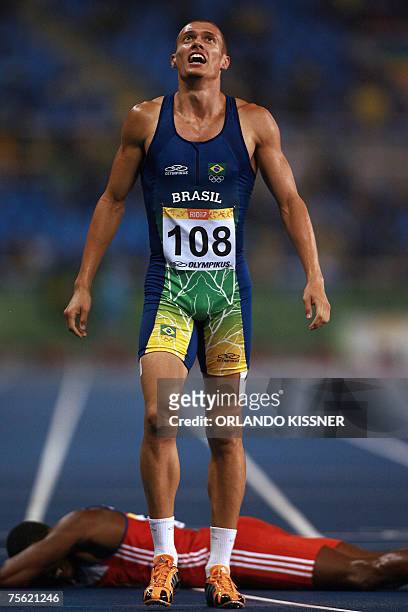 Rio de Janeiro, BRAZIL: Brazil's runner Carlos Chinin celebrates after winning the 1500m gold medal as Cuban Yordan Garcia lies on the floor 24 July...