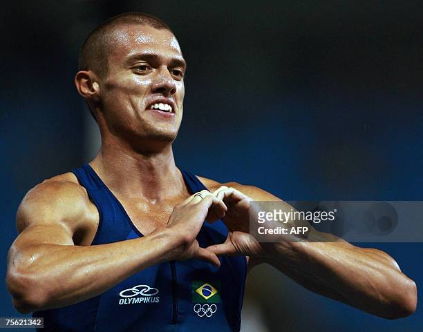 Rio de Janeiro, BRAZIL: Brazil's runner Carlos Chinin makes a heart sign with his hands celebrating his gold medal for the 1500m final 24 July 2007,...