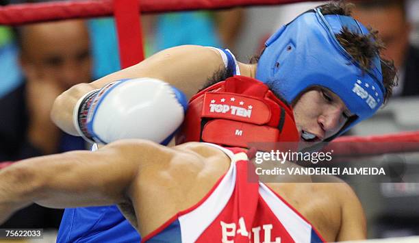 Rio de Janeiro, BRAZIL: Mexican boxer Carlos Cuadras tries to disengage from his rival Brazilian Dean Pereira, who tries to hit him below his guard,...