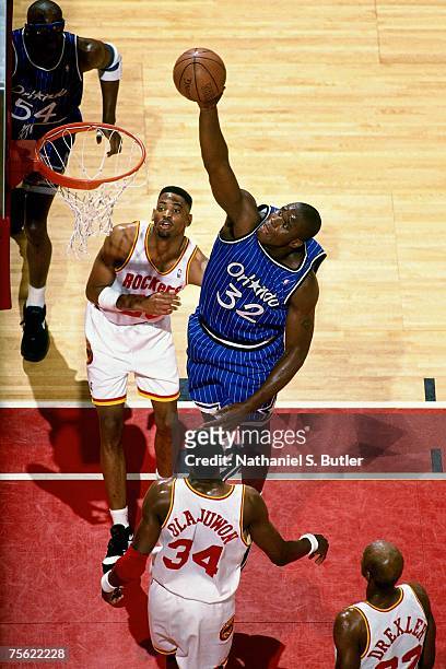 Shaquille O'Neal of the Orlando Magic attempts a shot against Hakeem Olajuwon of the Houston Rockets in Game Four of the 1995 NBA Finals played June...