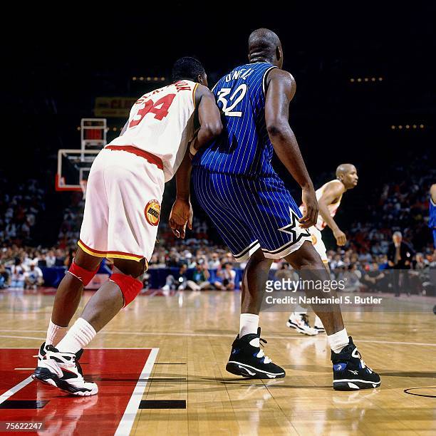 Shaquille O'Neal of the Orlando Magic battles for position against Hakeem Olajuwon of the Houston Rockets in Game Three of the 1995 NBA Finals at the...