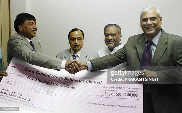 Mittal Investments Chairman Lakshmi N. Mittal hands over a symbolic cheque of INR 500 crore to Chairman and Managing Director of Hindustan Petroleum...
