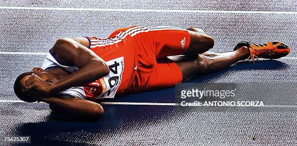 Cuban runner Yordan Garcia lies on the floor 24 July 2007 at the end of the 1500m final during the Pan American games in Rio de Janeiro, Brazil....