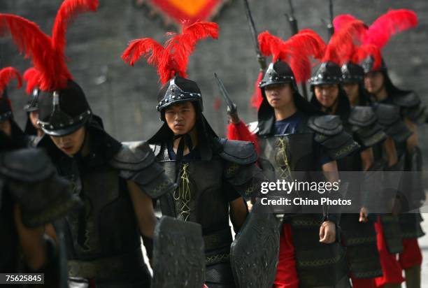 Actors dressed as ancient soldiers, parade during a performance in the Urn City of the South Gate of the Ming Dynasty City Wall on July 25, 2007 in...