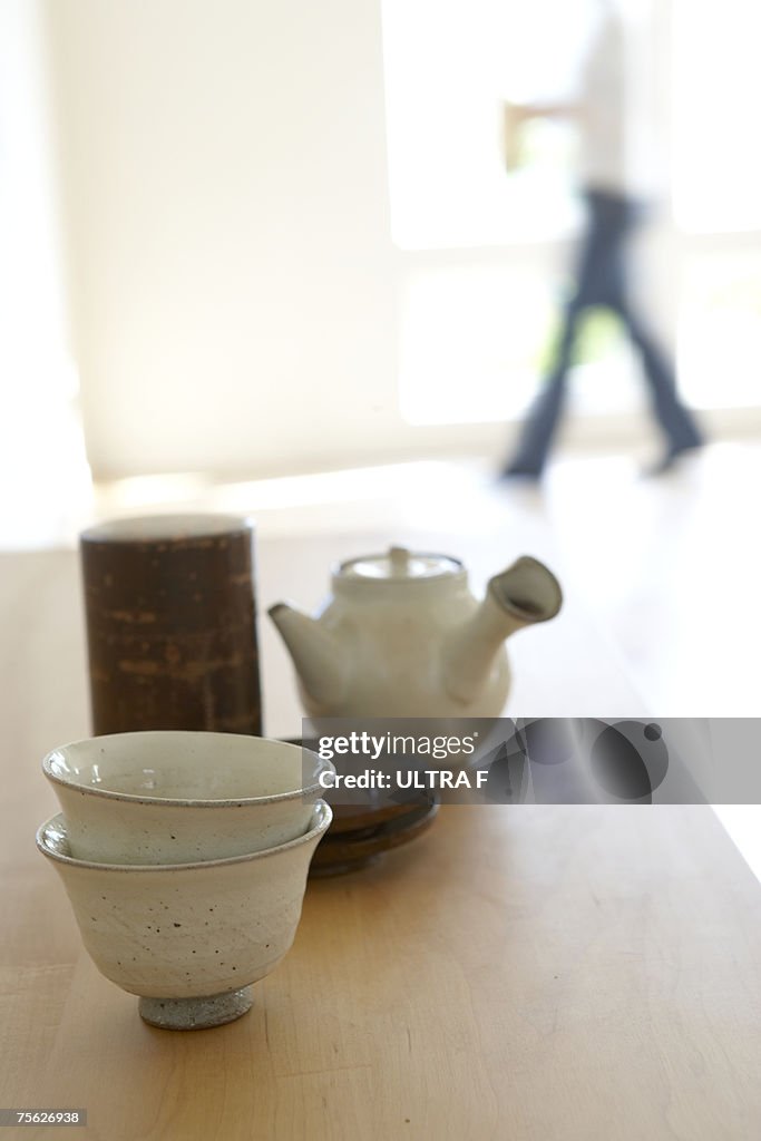 Japanese teapot and teacups on wooden table