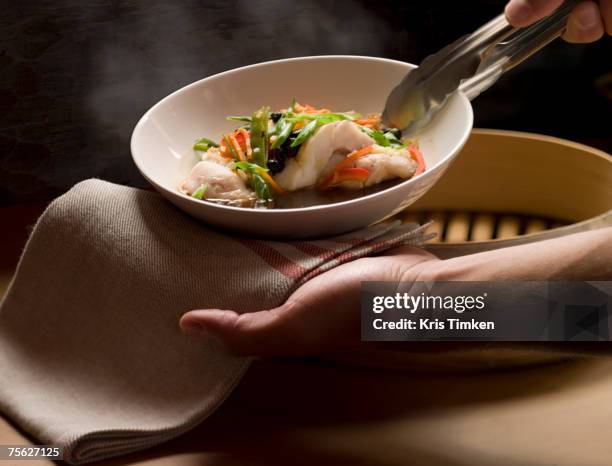 woman serving steaming white fish in broth, close-up of hands - bouillon stock pictures, royalty-free photos & images