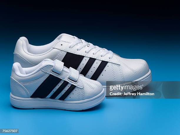 small and big sports shoes - big small stock-fotos und bilder