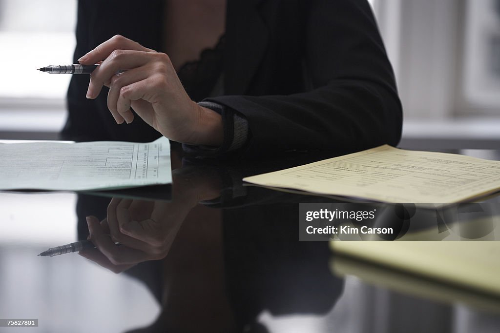 Mid section of women going over paperwork