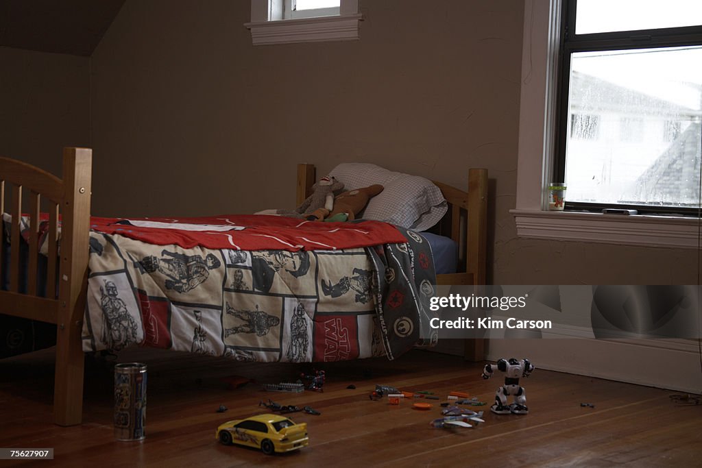 Child's bed and toys on floor at home