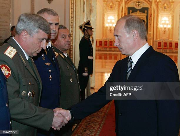 Moscow, RUSSIAN FEDERATION: Russian President Vladimir Putin shakes hands with Commander of the Siberian Military District, Colonel-General Alexander...