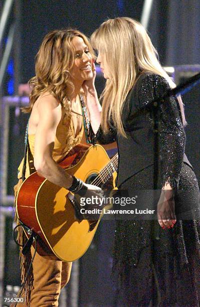 Recording artists Stevie Nicks and Sheryl Crow stand together on stage as they perform for the 10th anniversary celebration of the National Breast...