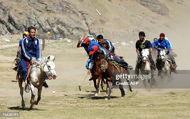 Kashmiri polo players fight for the ball during "Vijay Diwas" or Victory Day celebrations in Drass, some 160 kms east of Srinagar, 25 July 2007. The...