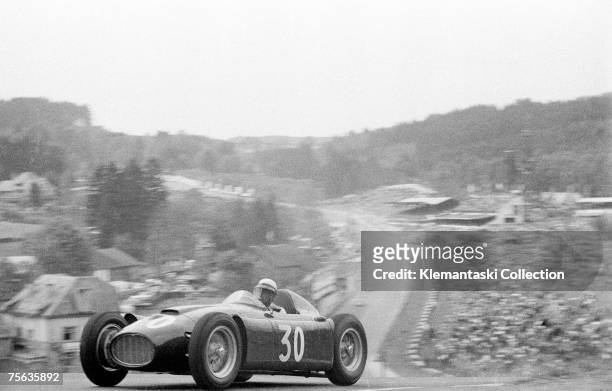 Italian racing driver Eugenio Castellotti comes over the top of Radillon after Eau Rouge in the Lancia D-50, during the Belgian Grand Prix at Spa...