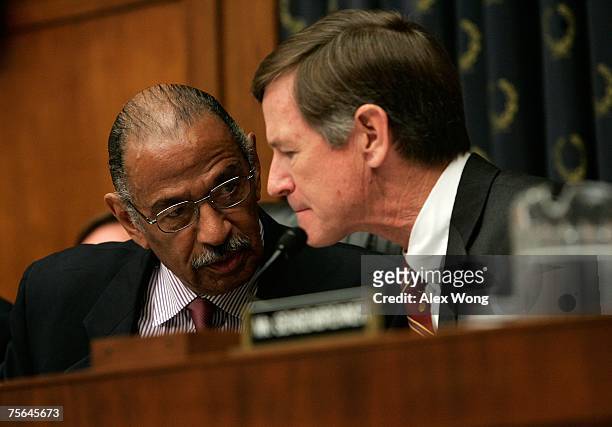 Chairman of U.S. House Judiciary Committee Rep. John Conyers talks with Rep. Lamar Smith during a mark up July 25, 2007 on Capitol Hill in...