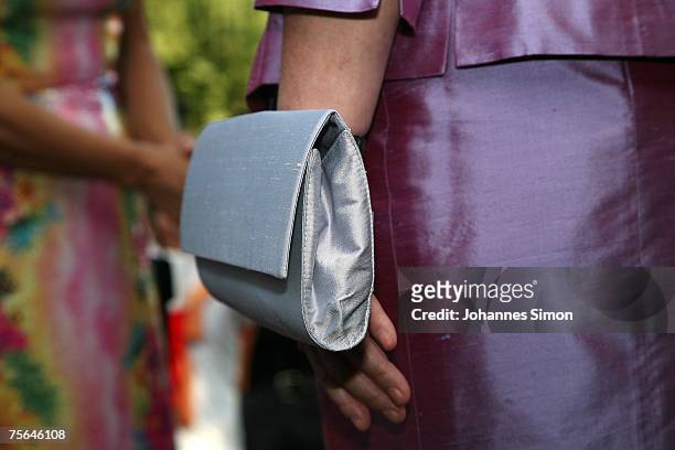 German Chancellor Angela Merkel carries a handbag during the first pause of the premiere of the Richard Wagner festival on July 25, 2007 in Bayreuth,...