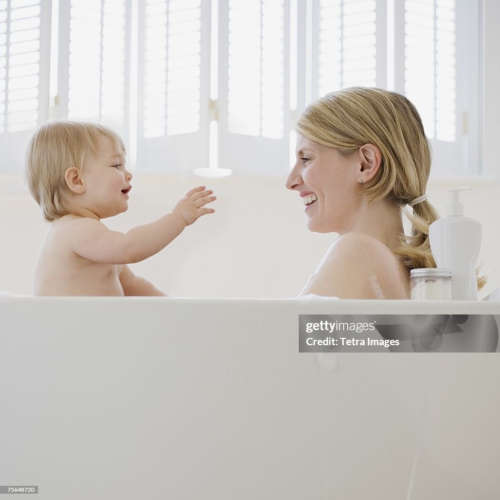 Mother and baby in bathtub