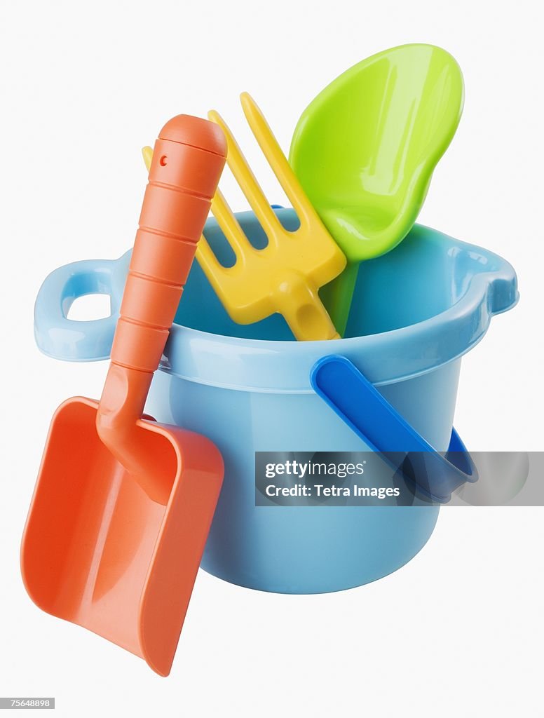 Close up of toy pail and shovels