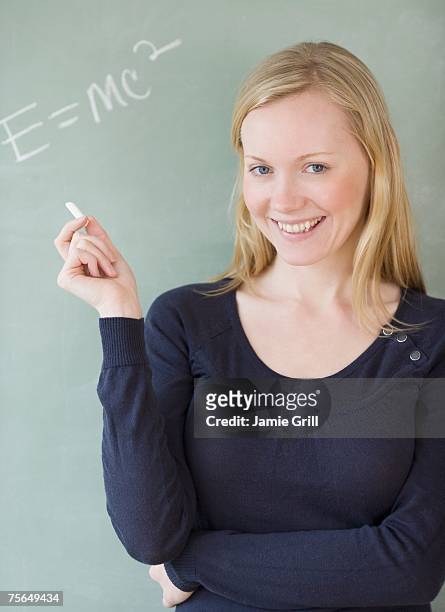 woman standing in front of blackboard - einstein stock-fotos und bilder