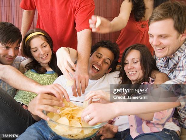 friends eating chips - potato chips stock pictures, royalty-free photos & images