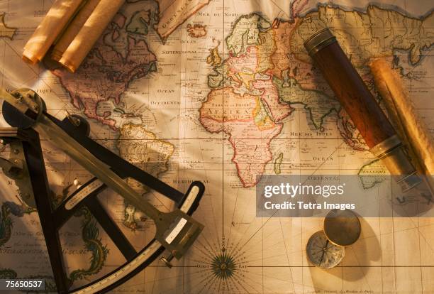 octant, compass and telescope on nautical map - antique world map stock pictures, royalty-free photos & images