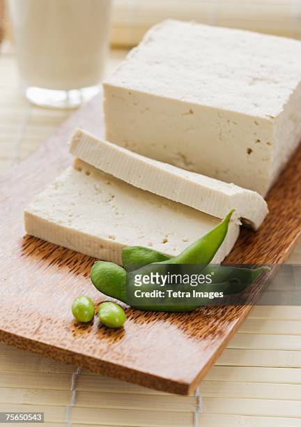soybeans and sliced tofu on table - tofu stock pictures, royalty-free photos & images