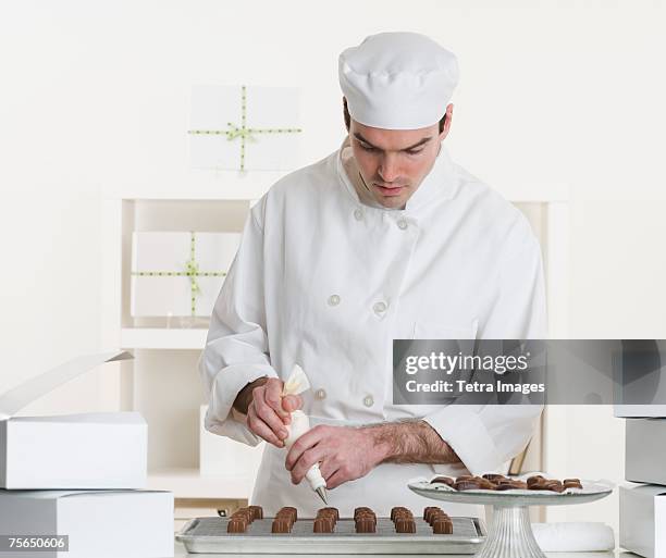 male pastry chef in kitchen - pastry chef stock pictures, royalty-free photos & images