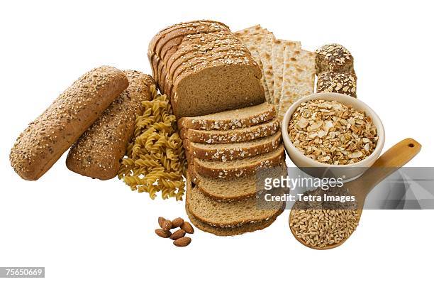 close up of assorted grains and bread - weizenvollkorn stock-fotos und bilder