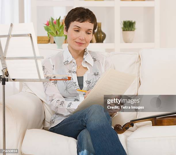 woman reading violin sheet music - the inspiration awards for women inside stock pictures, royalty-free photos & images