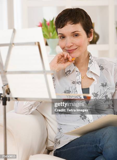 woman sitting next to sheet music on stand - the inspiration awards for women inside stock pictures, royalty-free photos & images